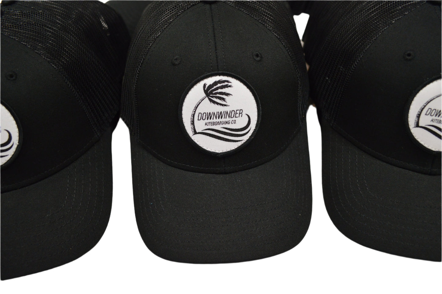 Black Hat with a patch of the Downwinder Kiteboarding Co. Logo