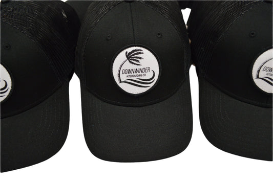 Black Hat with a patch of the Downwinder Kiteboarding Co. Logo